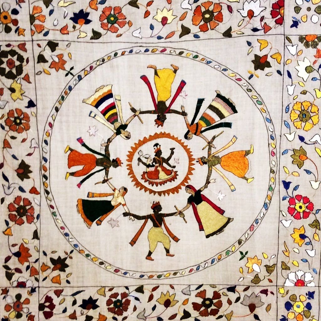 This picture is depicting Rasa Leela from the ancient times. The Chamba Rumal or Chamba handkerchief is an embroidered handicraft that was once promoted under the patronage of the former rulers of Chamba kingdom. It is a common item of gift during marriages with detailed patterns in bright and pleasing colour schemes.