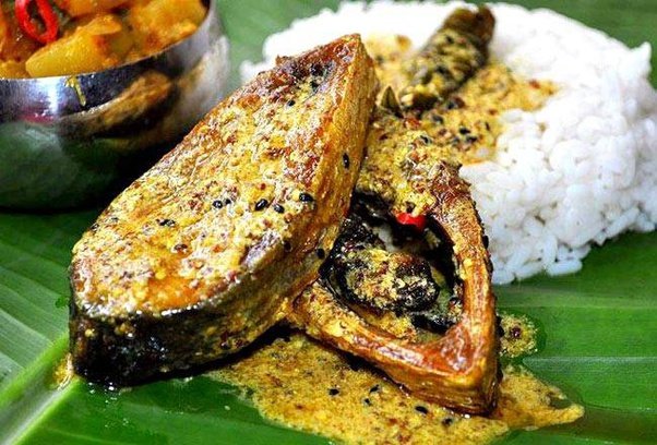 This dish is called Sorshe Illish or Musturd Hilsa. Prepared with Illish or Hilsa Fish, this dish is mainly served with Rice and lemon.